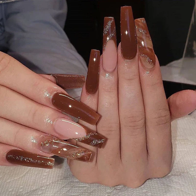 Artful gel nails in elegant high-gloss design with glitter accents and stylish patterns Stornfield