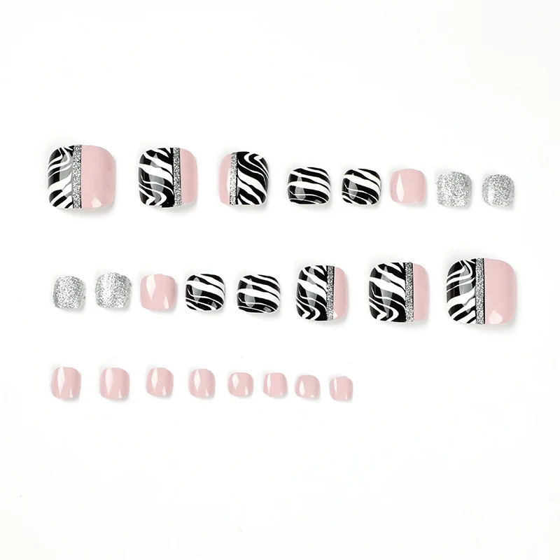 Artistic toenail art with zebra pattern and glitter accents Stornfield