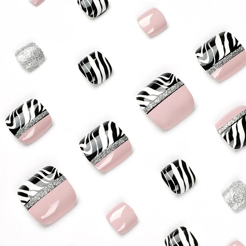 Artistic toenail art with zebra pattern and glitter accents Stornfield