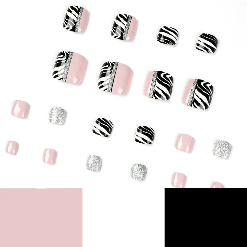 Artistic toenail art with zebra pattern and glitter accents Stornfield
