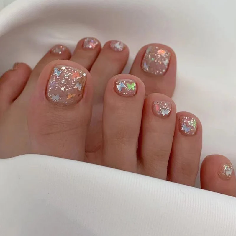 Artful toenail art with glitter and butterfly designs Stornfield