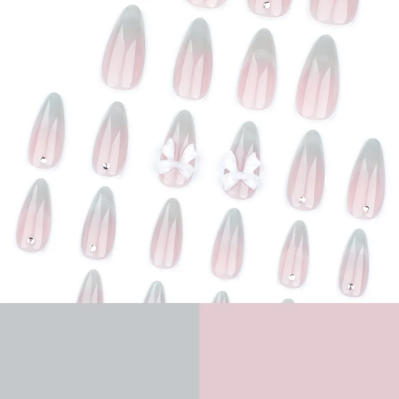 Elegante Stiletto-Nägel mit Glitzer- und Schleifenakzenten Karnz