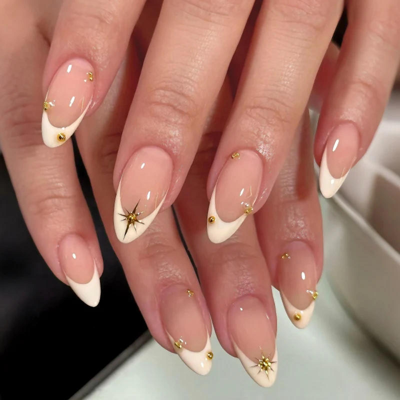 Artistic French-tip nail art with glitter and elegant embellishments Stornfield