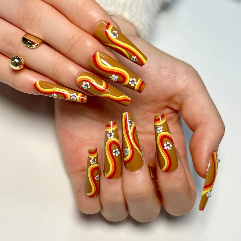 Artful acrylic nails with wave design and floral embellishments Stornfield