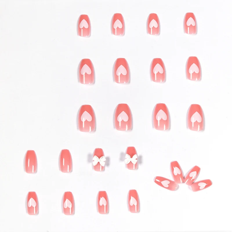 Artistic acrylic nails with heart and bow motifs Stornfield