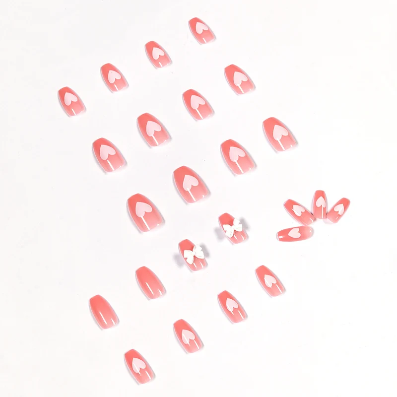 Artistic acrylic nails with heart and bow motifs Stornfield