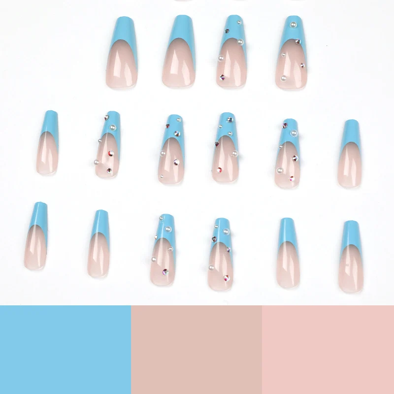 Artificial nail extensions with glitter and pearl accents Stornfield