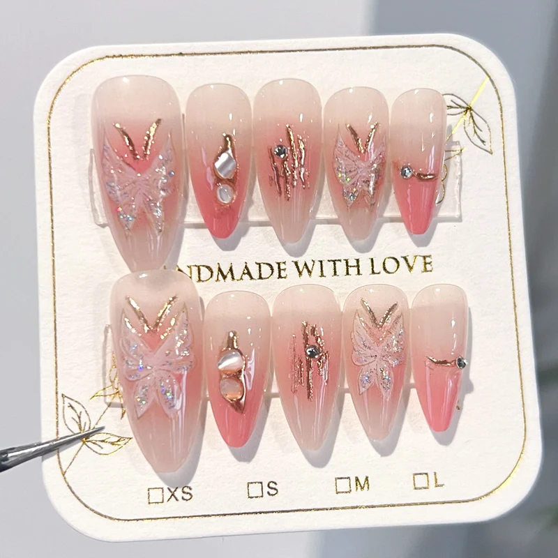 Artificial nail extensions with floral motifs and glitter accents Stornfield