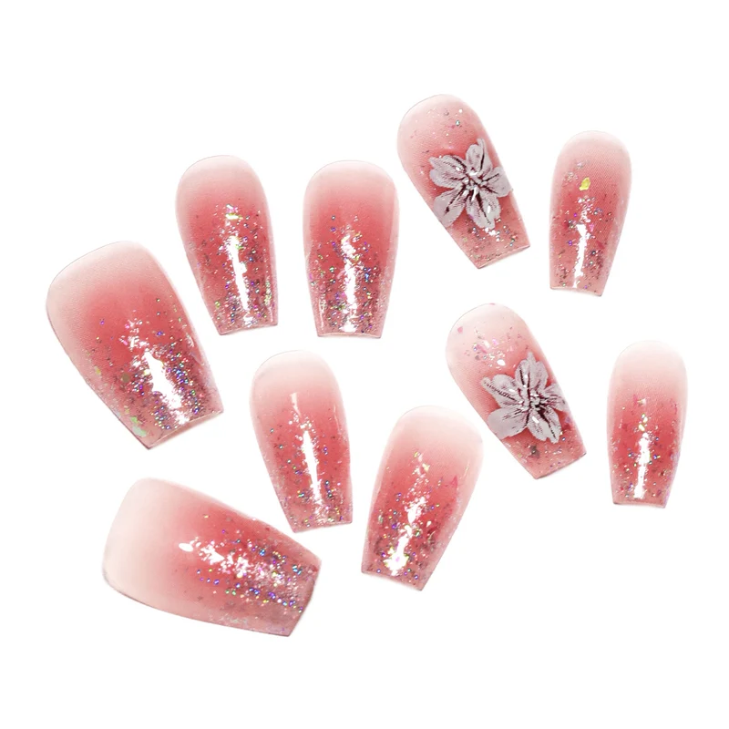 Artificial nail extensions with floral design and glitter accents Stornfield