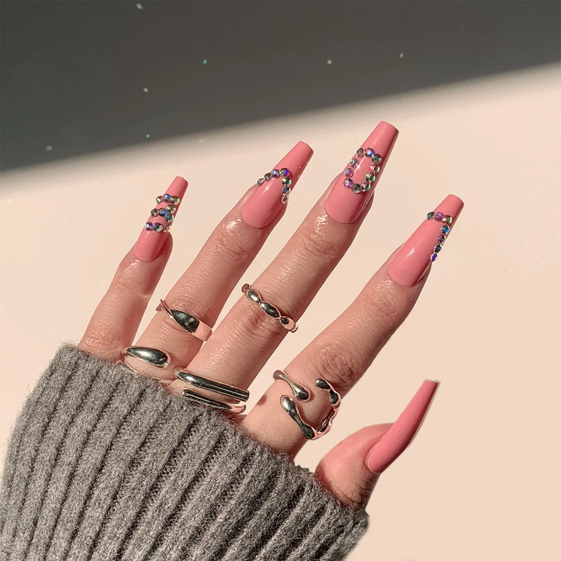 Artificial nail extensions with elegant rhinestone embellishments Stornfield