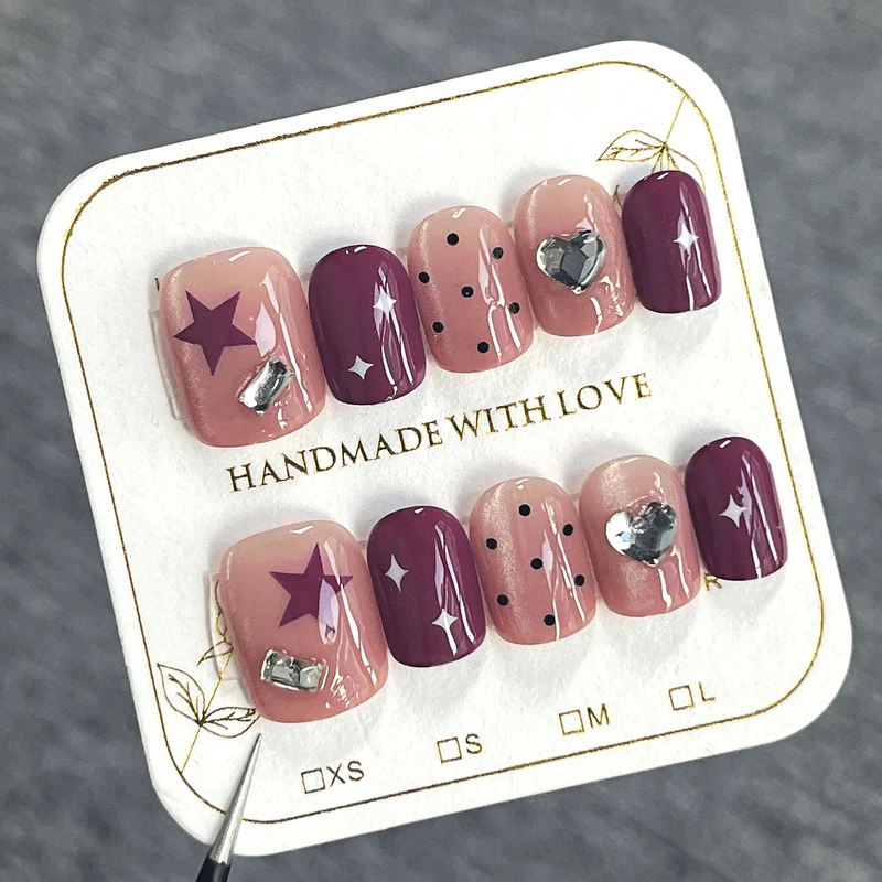 Artificial nail extensions with unique jewelry accents Stornfield