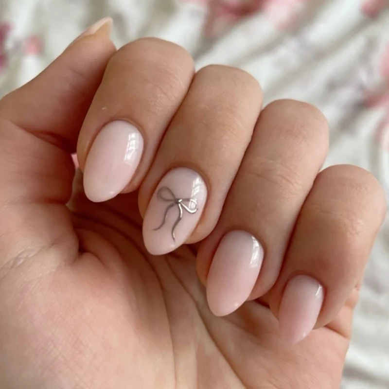 Artificial nail art with playful dots and bows Stornfield