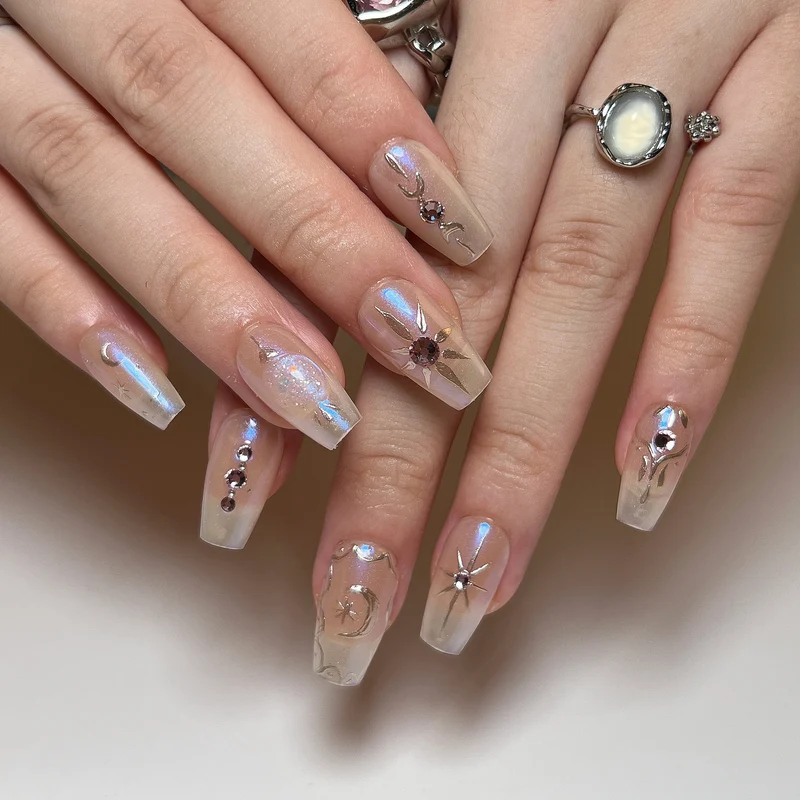 Artificial nail art with elegant rhinestone and glitter effects Stornfield