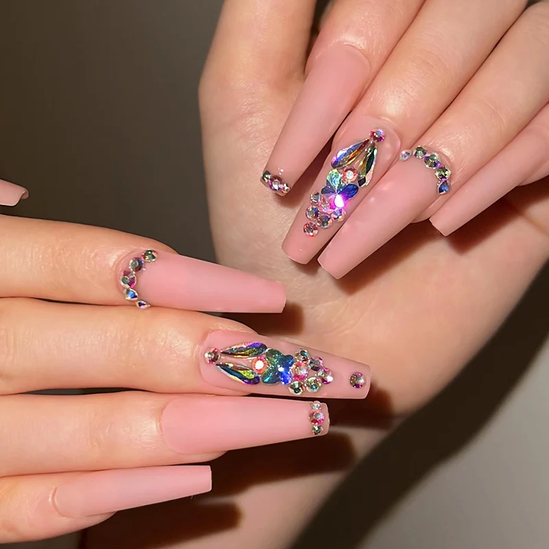 Artistic acrylic nails with glitter and rhinestone embellishments Stornfield