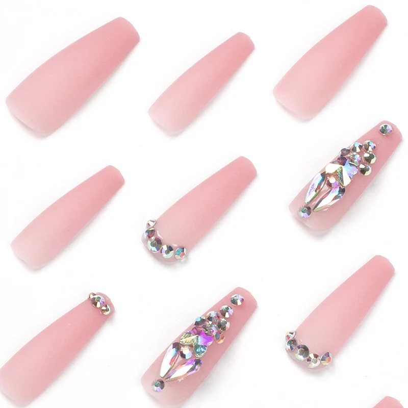 Artistic acrylic nails with glitter and rhinestone embellishments Stornfield
