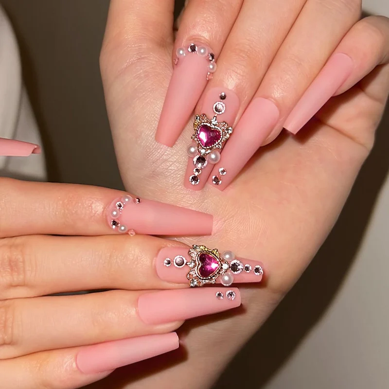Creative artificial nails with heart-shaped decorative accents Stornfield