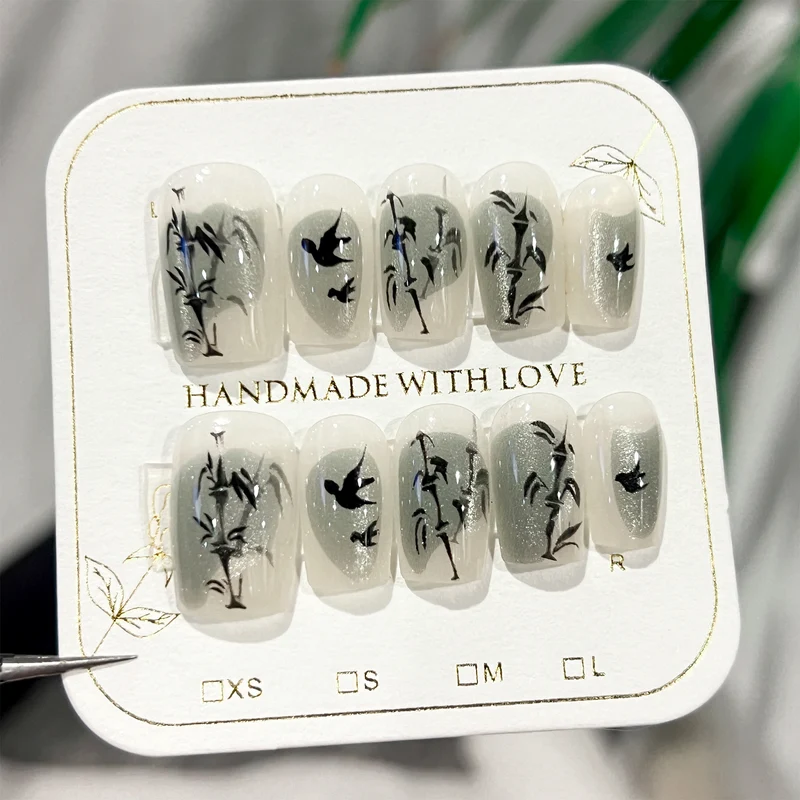 Handcrafted acrylic nails with decorative bird motifs Stornfield