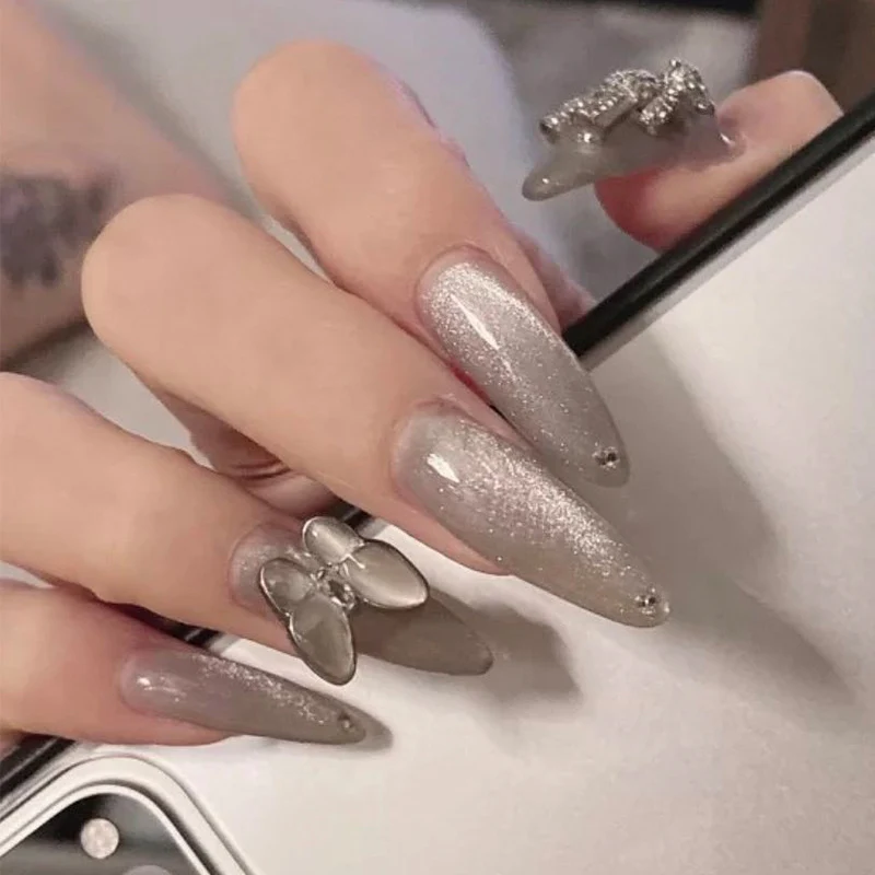 Glamorous stiletto nails with radiant glitter and elegant 3D design Stornfield