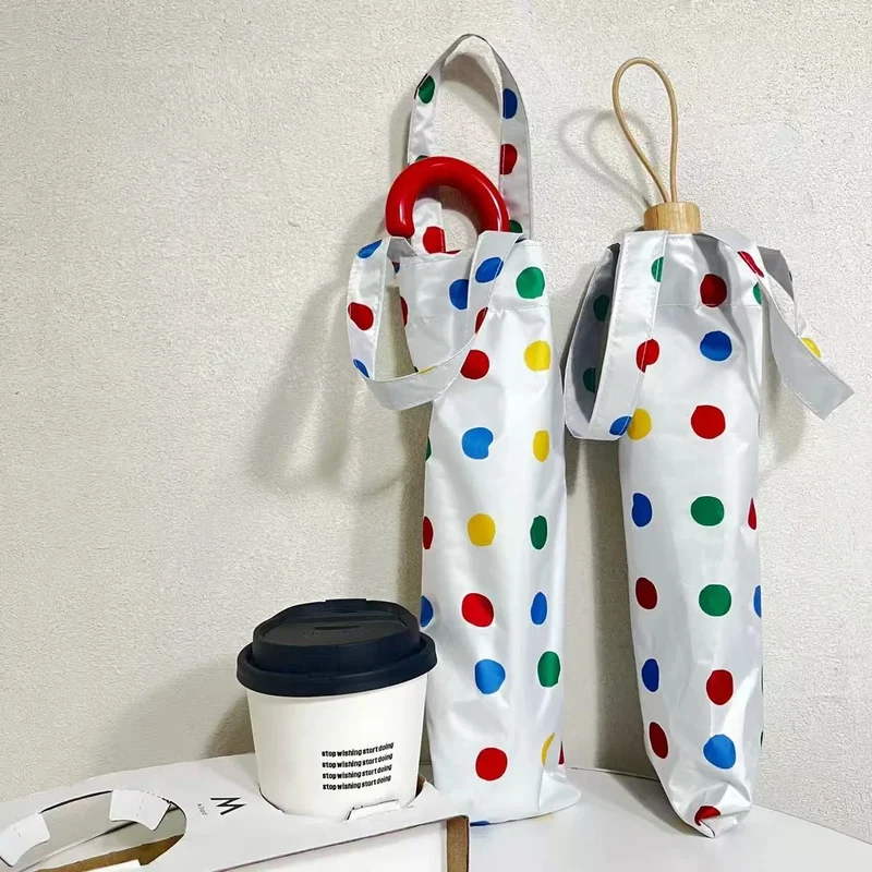 Dame designer Faltregnese med fargerikt prikkemønster Luvikno