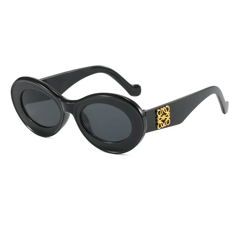 Dame moteriktig solbrille med oval ramme og gullapplikasjoner Luvikno