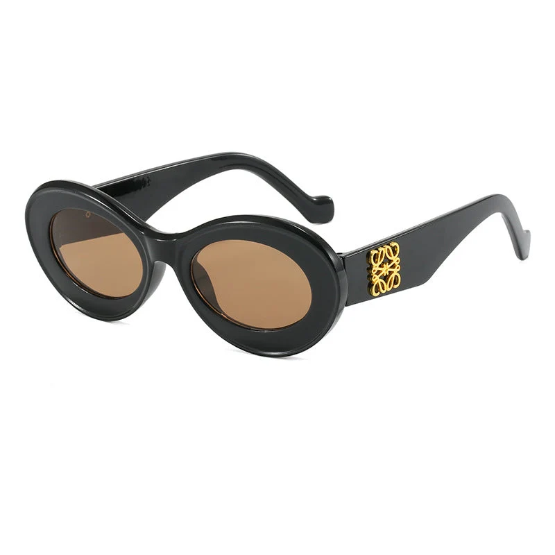 Dame moteriktig solbrille med oval ramme og gullapplikasjoner Luvikno