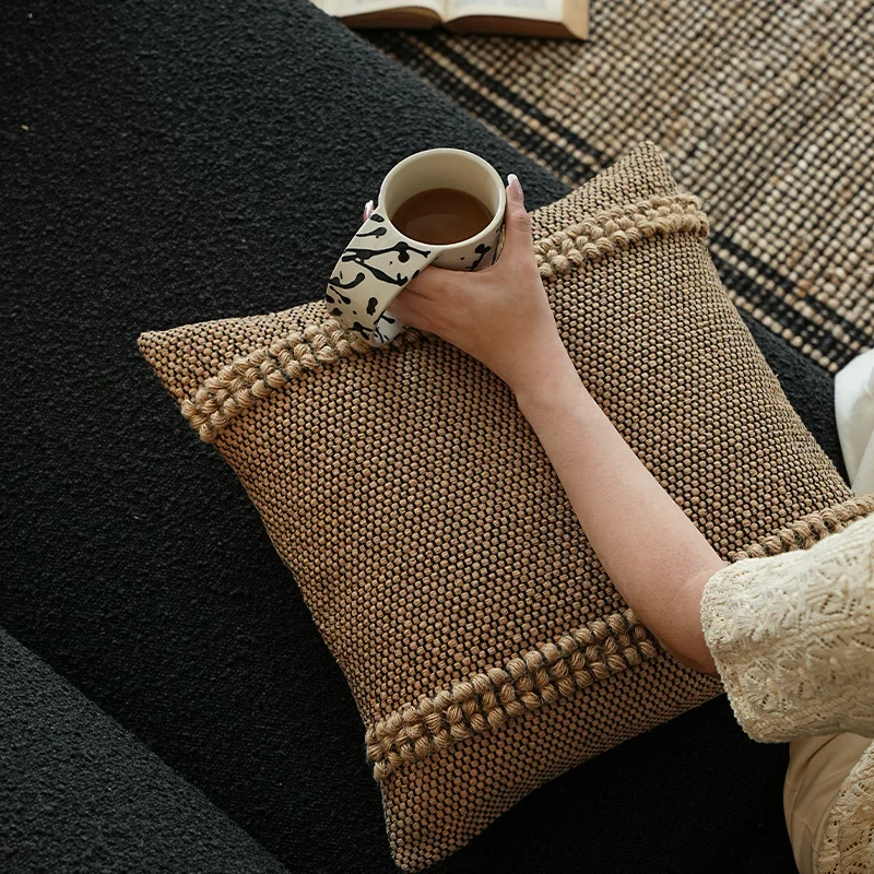 Handwoven structured cushion cover made of cotton blend with pompom trim Stornfield