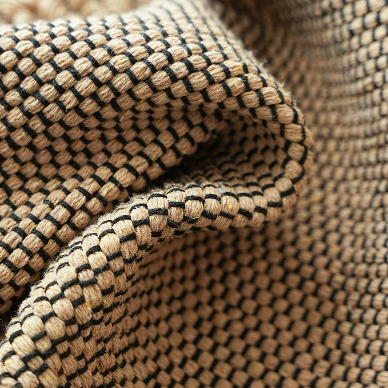 Handwoven structured cushion cover made of cotton blend with pompom trim Stornfield