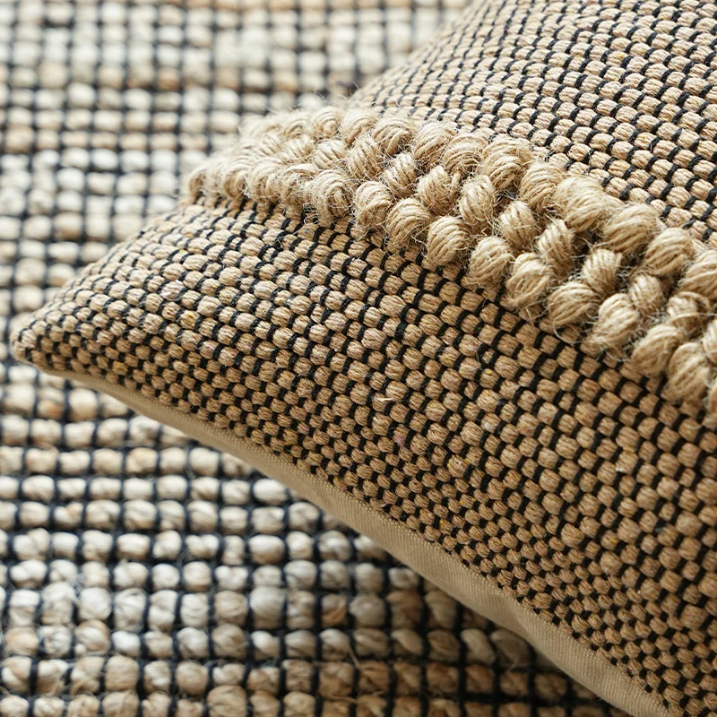 Handwoven structured cushion cover made of cotton blend with pompom trim Stornfield