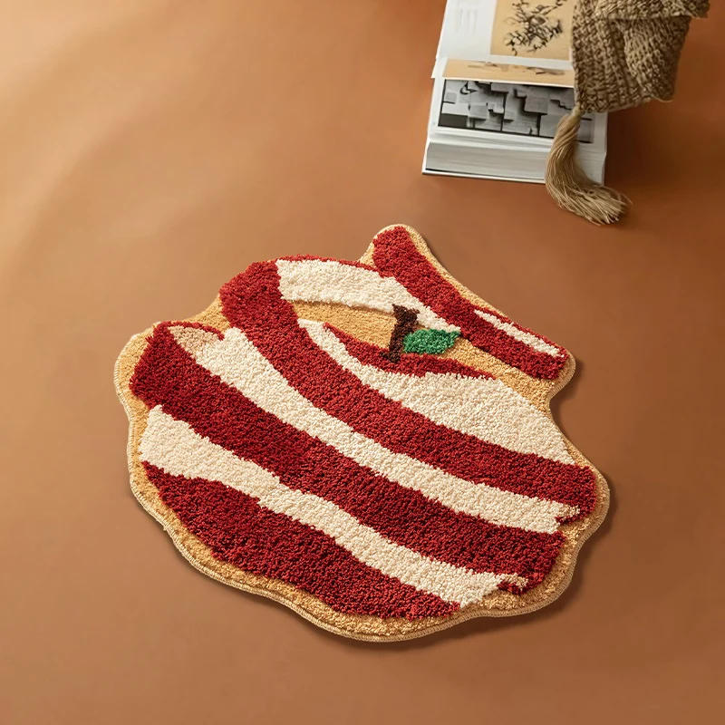 Hand-tufted decorative doormat in apple shape made of cotton blend with non-slip bottom Stornfield