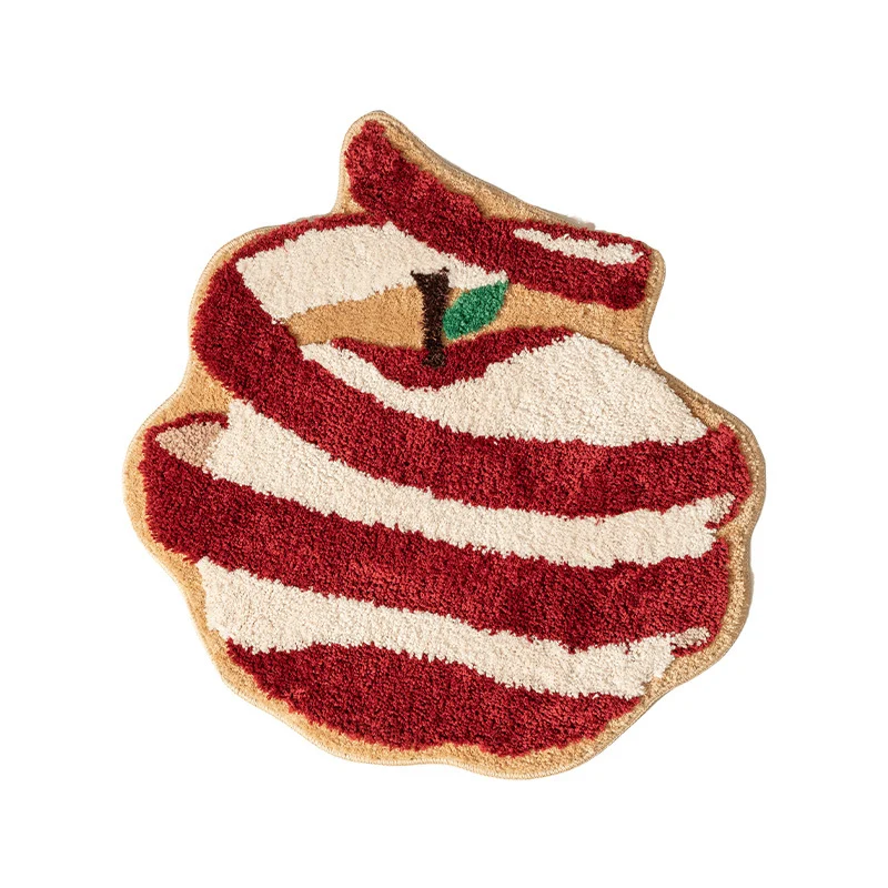 Hand-tufted decorative doormat in apple shape made of cotton blend with non-slip bottom Stornfield