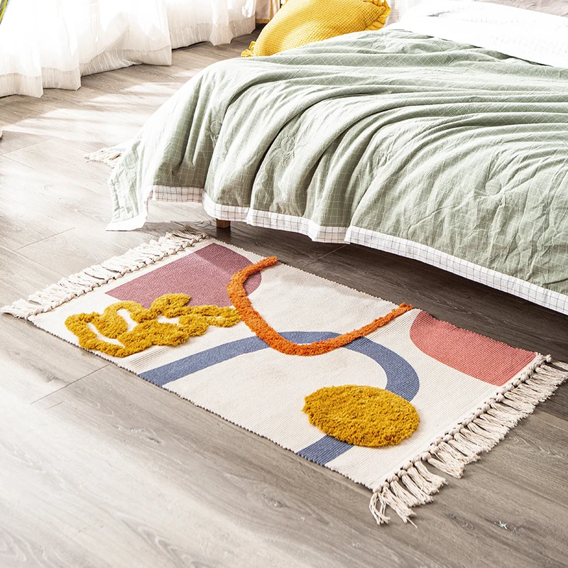 Hand-tufted bathroom mat with fringes, decorative dot-and-dash pattern and non-slip backing Stornfield