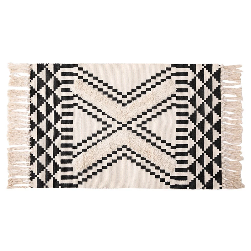 Hand-tufted bathroom mat with fringes, decorative dot-and-dash pattern and non-slip backing Stornfield