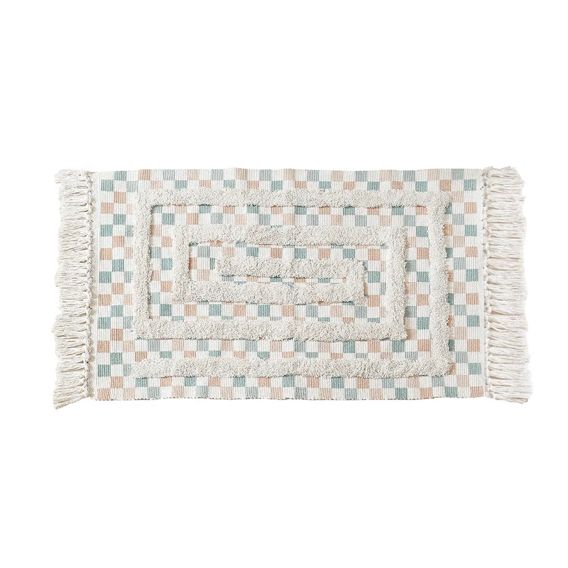 Hand-tufted bathroom mat with fringes, decorative dot-and-dash pattern and non-slip backing Stornfield