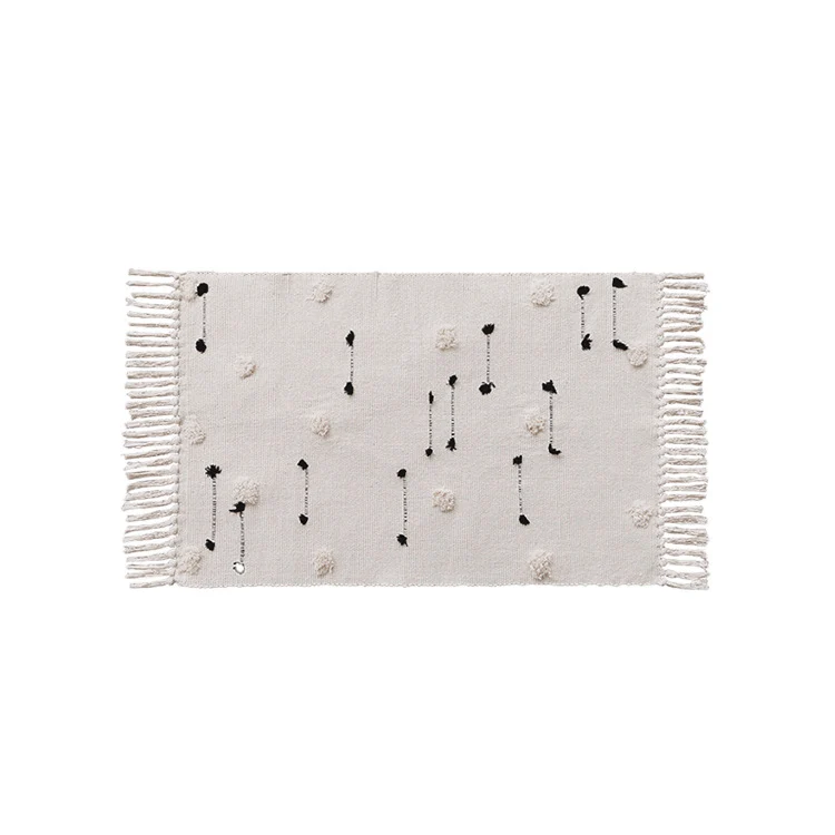 Hand-tufted bathroom mat with fringes, decorative dot-and-dash pattern and non-slip backing Stornfield