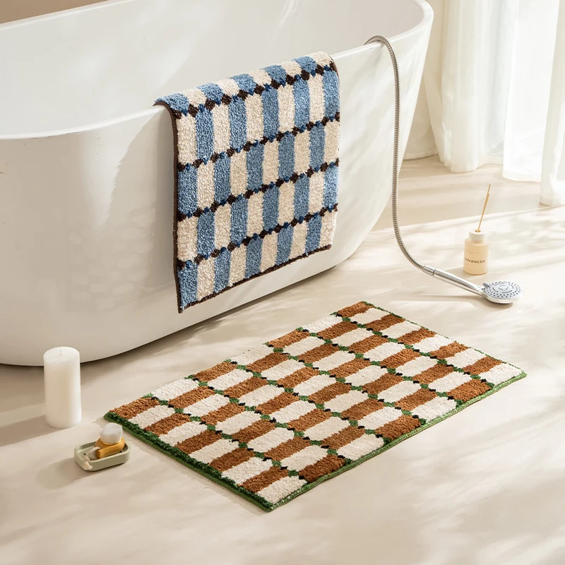 Hand-tufted bathroom mat with a velvety pile, non-slip latex backing, and geometric honeycomb check pattern Stornfield