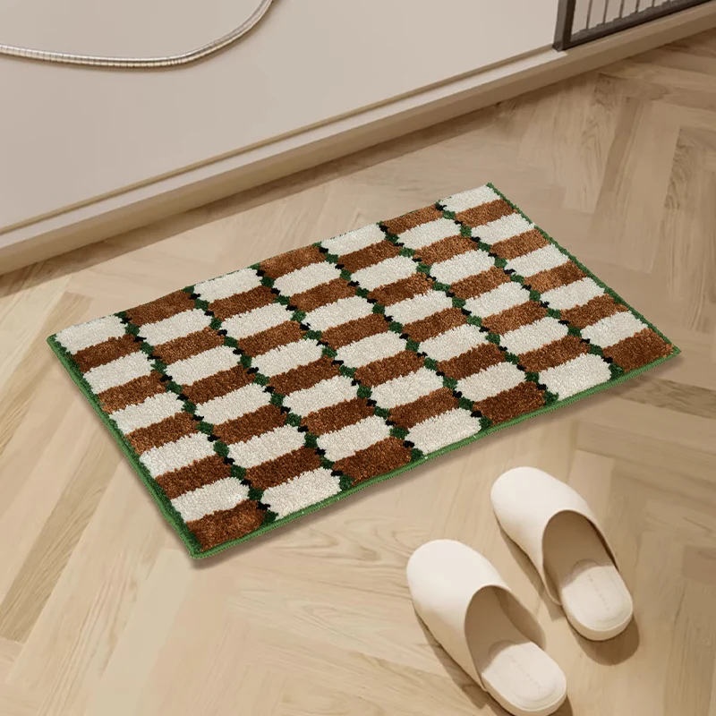 Hand-tufted bathroom mat with a velvety pile, non-slip latex backing, and geometric honeycomb check pattern Stornfield
