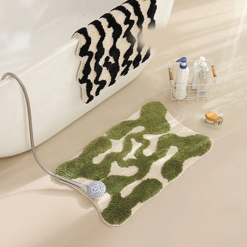 Hand-tufted bathroom bath mat with non-slip backing and textured square relief Stornfield