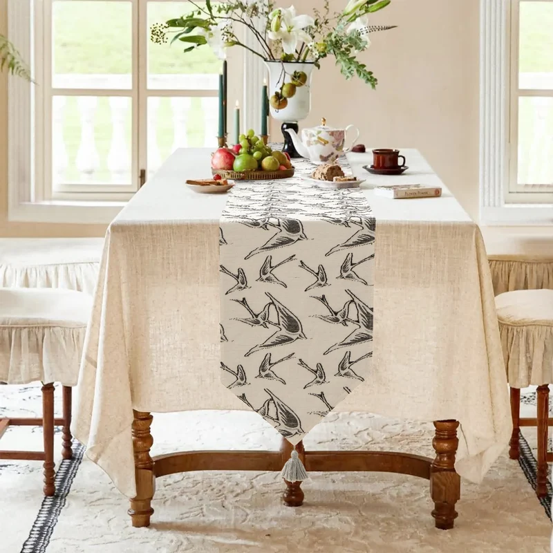 Woven double-sided linen table runner with tassels and hand-drawn swallow print Stornfield