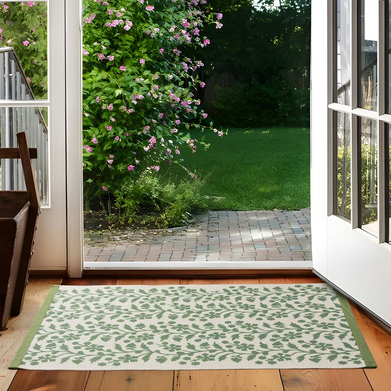 Woven table runner with floral vinyl print look and reinforced overlock stitching Stornfield
