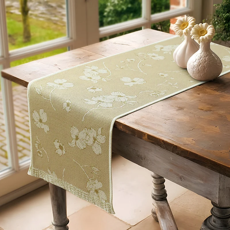 Woven table runner with floral jacquard pattern and fringed edge Stornfield