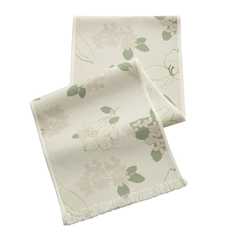 Woven table runner with floral jacquard pattern and fringed edge Stornfield
