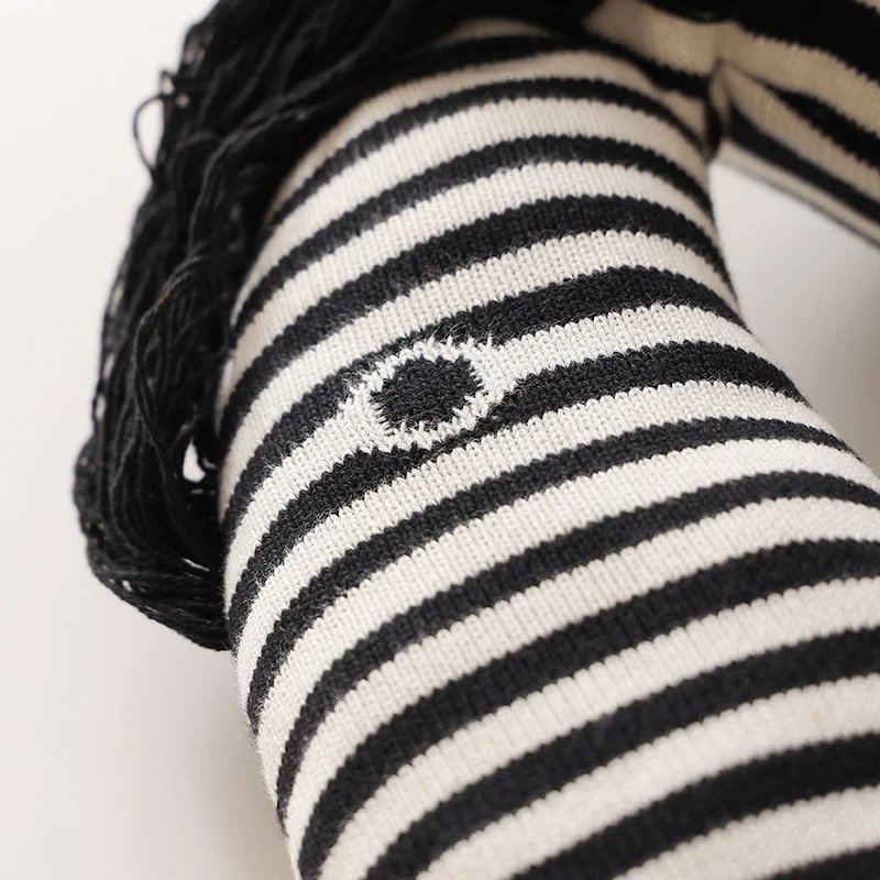 Striped decorative knitted cushion in animal shape with fringes and four-legged look Stornfield