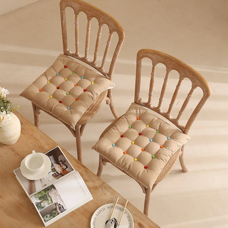 Padded quilted seat cushion with colorful button applications and non-slip underside Stornfield