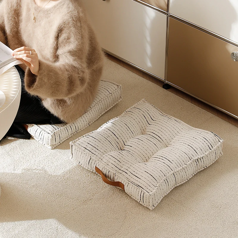 Padded square seat and floor cushion with quilted tufted padding and carrying handle Stornfield