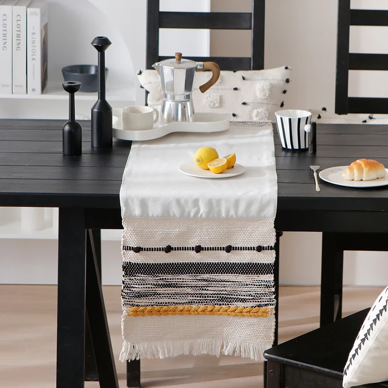 Woven cotton table runner with boho stripes, fringes, and textured woven edge Stornfield