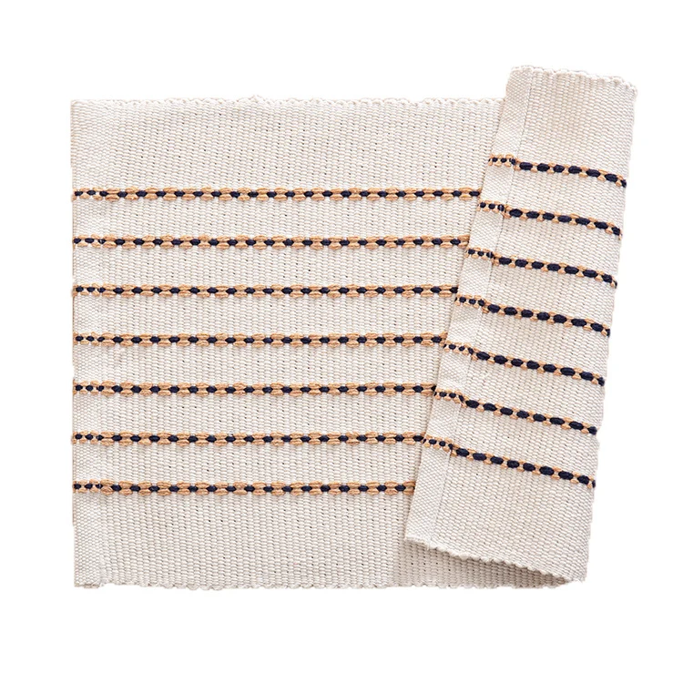 Woven placemats and table runners made of cotton blend with fine dot stripes and knot applications Stornfield