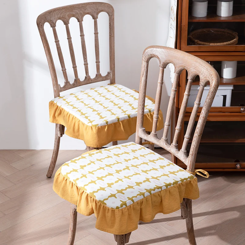 Padded chair cushion with ties, ruffled edge and embroidered hole pattern look Stornfield
