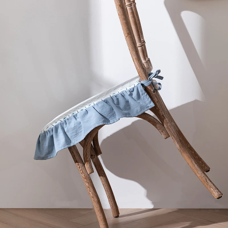 Padded chair cushion with ties, ruffled edge and embroidered hole pattern look Stornfield