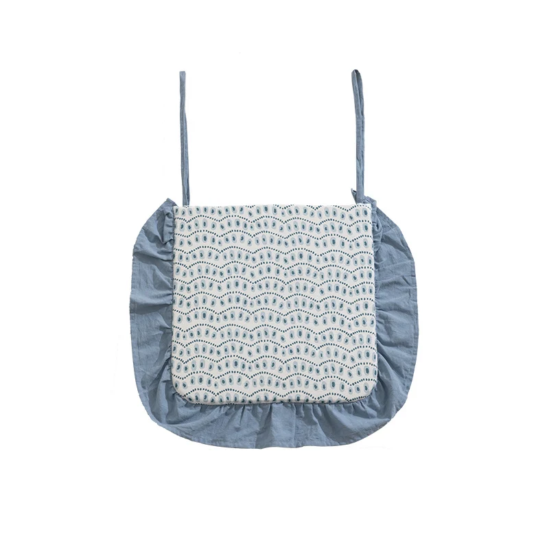 Padded chair cushion with ties, ruffled edge and embroidered hole pattern look Stornfield