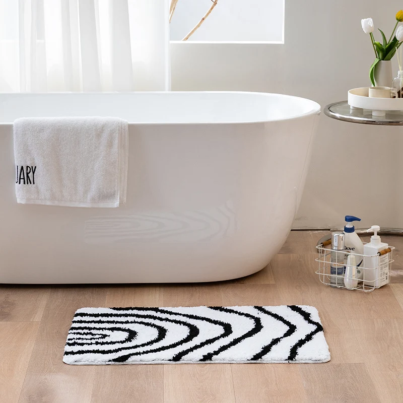 Fluffy bath mat in a graphic wave relief with anti-slip base Stornfield